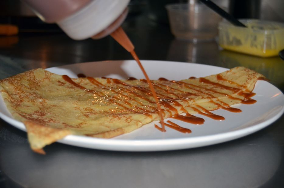Head chef and owner of Fleur de Sel, Gregory Alexandre, tops a sweet crepe with caramel sauce.