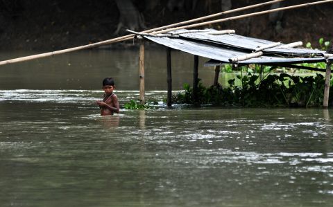 A child stands in floodwater in Naleni Village. More than 2,000 villages have been flooded. 