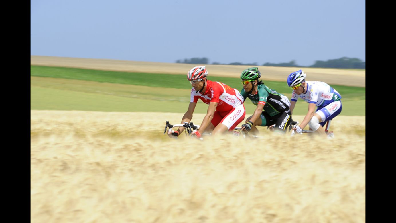France's David Moncoutie, Japan's Yukiya Arashiro, and France's Anthony Delaplace ride in a breakaway.  