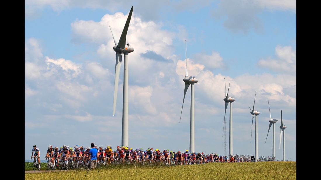The peloton passes by windmills on Wednesday.