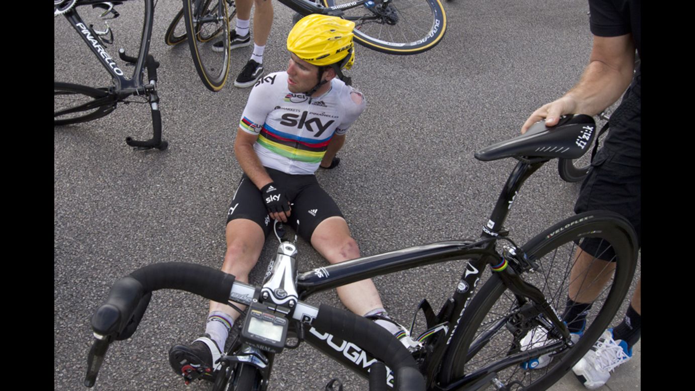 An injured Mark Cavendish of Great Britain sits on the pavement just after crashing near the end of the 214-kilometer Stage 4.