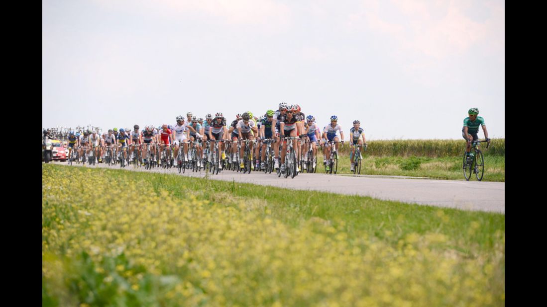 The pack of cyclists streams along a country road during Stage 4.