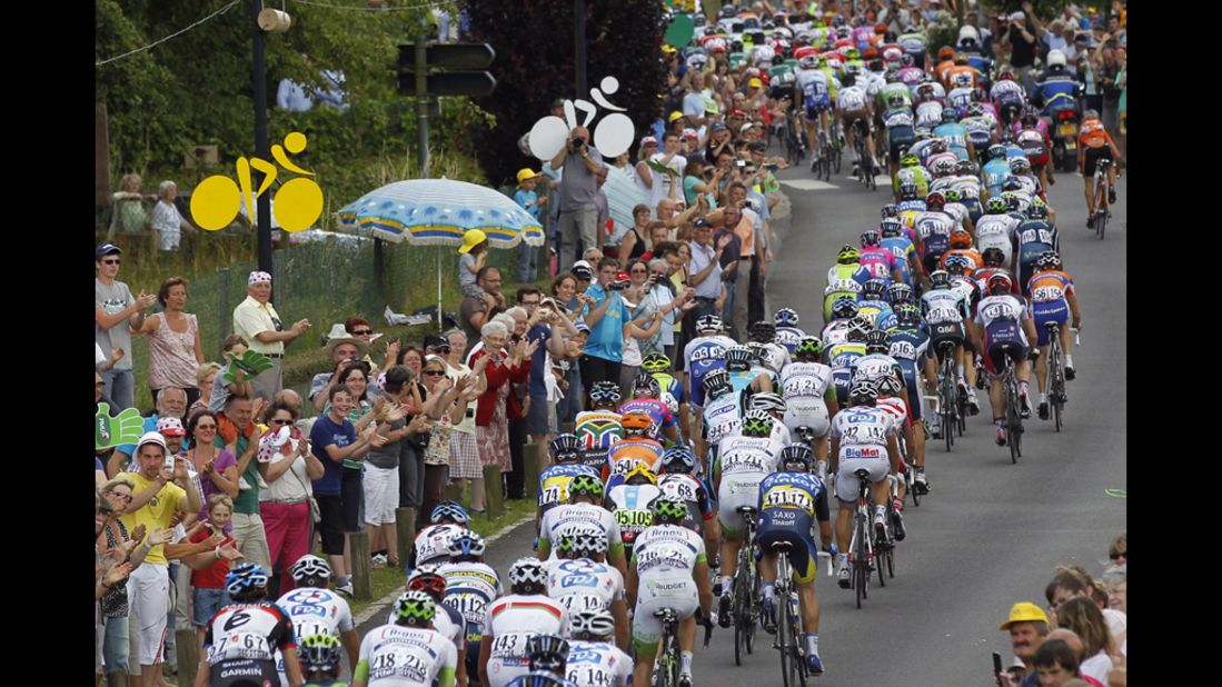 The pack of riders cycles past spectators during Stage 4.