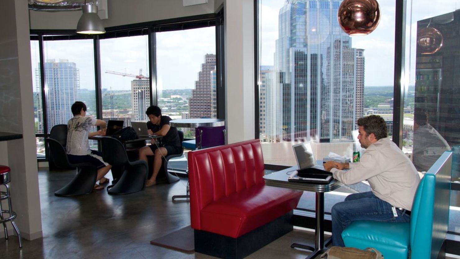 With the city's skyline in the background, tech entrepreneurs work at Austin's Capital Factory.