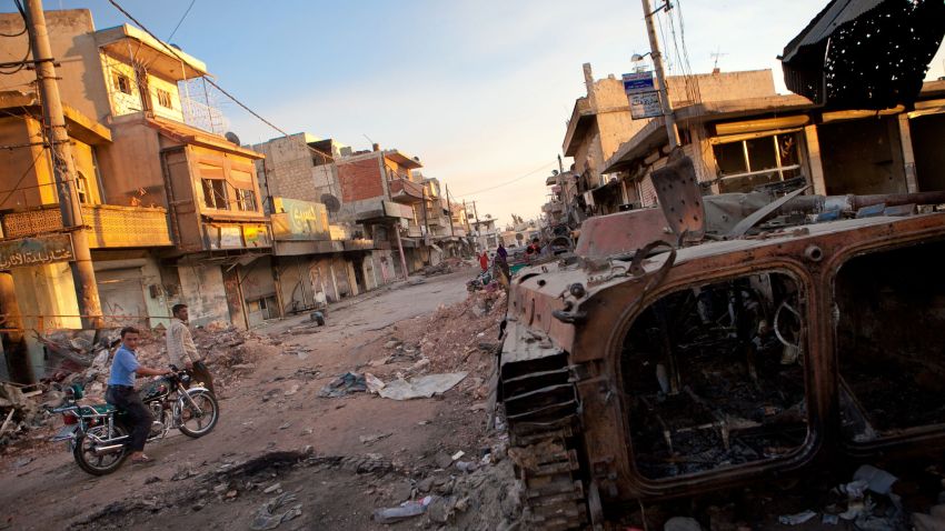 A destroyed Syrian forces tank remains in a damaged street in Atareb in northern Aleppo province on July 2, 2012. The majority of residents in Atareb have fled the town due to heavy fighting between Syrian forces and rebels. The last convoy of Syrian army has reportedly left the town few days ago and residents are slowly returning to claim their possessions and check their homes. AFP PHOTO/LO (Photo credit should read LO/AFP/GettyImages)