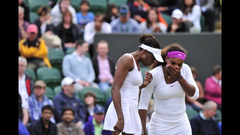 American Venus Williams confers with sister Serena, right, during their third round women's doubles match against American Bethanie Mattek-Sands and India's Sania Mirza on Wednesday.