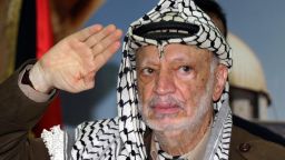 RAMALLAH, -: Palestinian leader Yasser Arafat salutes during a meeting with supporters in his office in the West Bank city of Ramallah 27 September 2004. The Intifada has developed into one of the grimmest chapters in the life of Yasser Arafat, who is confined to his headquarters, showered with death threats and the target of growing calls for reform.AFP PHOTO/JAMAL ARURI (Photo credit should read JAMAL ARURI/AFP/Getty Images) 
