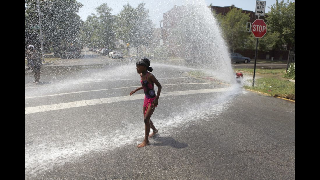 Keshyra Pitts, 7, plays in the spray of a hydrant in Chicago on Wednesday.