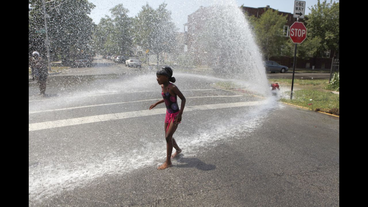 Keshyra Pitts, 7, plays in the spray of a hydrant in Chicago on Wednesday.