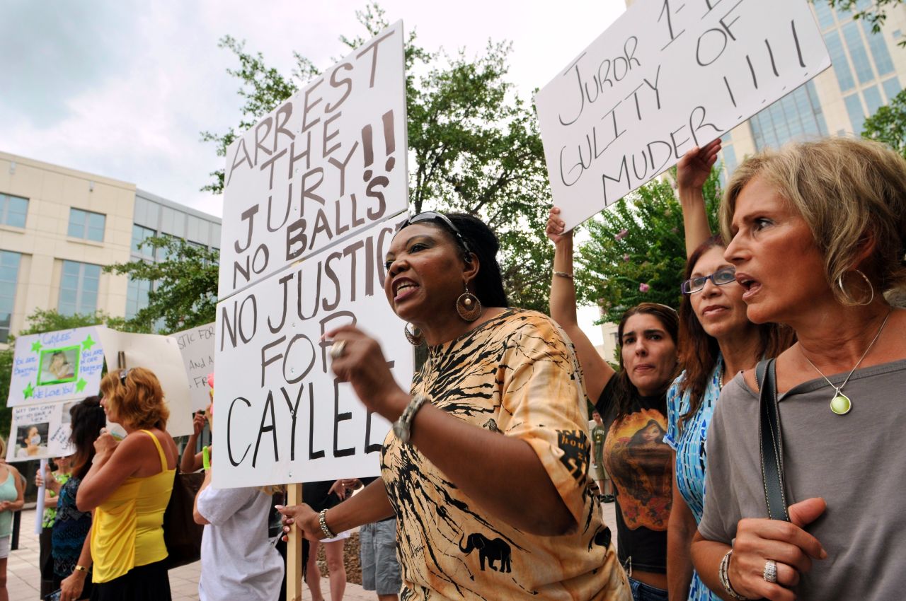<strong>July 2011: </strong>The not-guilty charge divided many people who followed the case. Flora Reece, center, of Orlando is seen protesting the verdict outside the Orange County Courthouse.