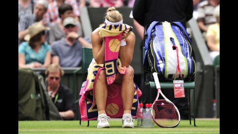 Kerber buries her head in her towel during a break between games in her Ladies' Singles semifinal defeat to Radwanska.