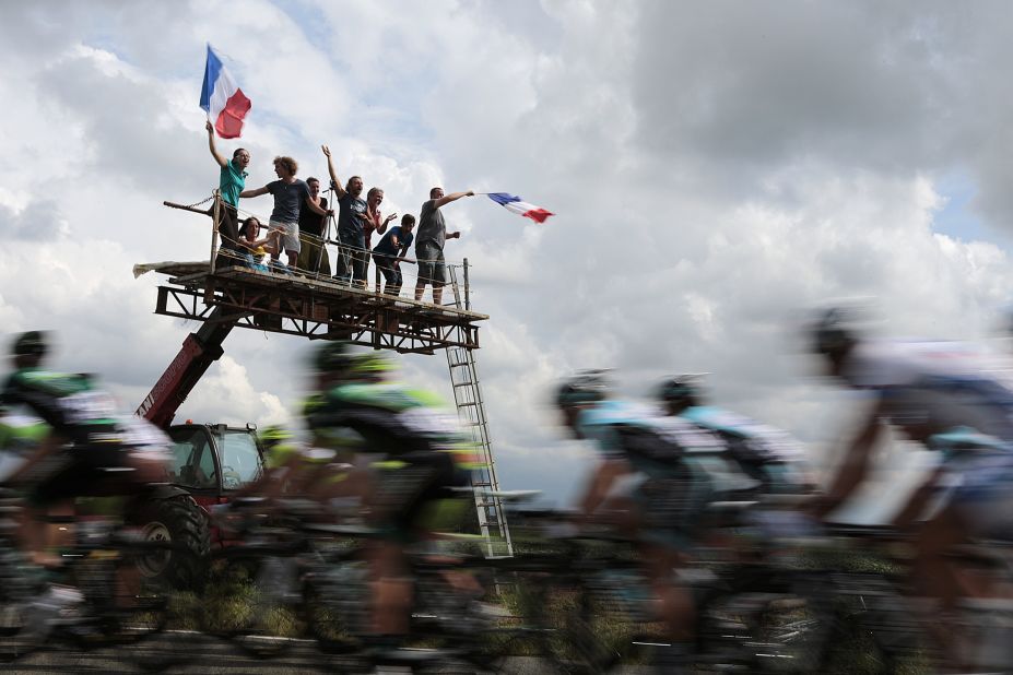 Fans wave French flags and cheer on riders Thursday as the main group passes on the way from Rouen, where Stage 5 of the race started, to Saint-Quentin.
