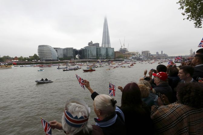 Crowds cheer as the flotilla passes the Shard during the Thames Diamond Jubilee Pageant on the River Thames in London on June 3, 2012.