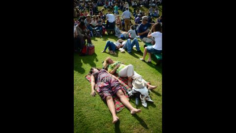 Spectators relax in the afternoon sun on Henman Hill (aka Murray Mound) on Thursday.