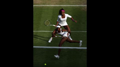 Serena Williams, top,  and Venus Williams of the United States team up in their women's doubles quarter-final match against Raquel Kops-Jones and Abigail Spears of the United States on Thursday.
