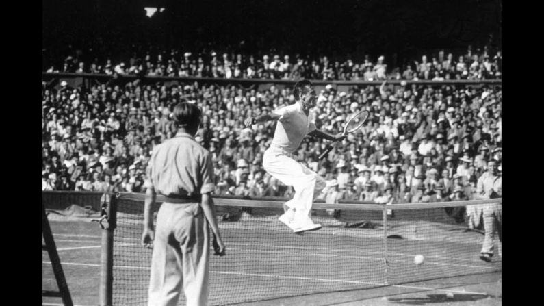 Perry jumps the net on July 1, 1936, after beating Donald Budge of the United States to win the men's singles semifinal.