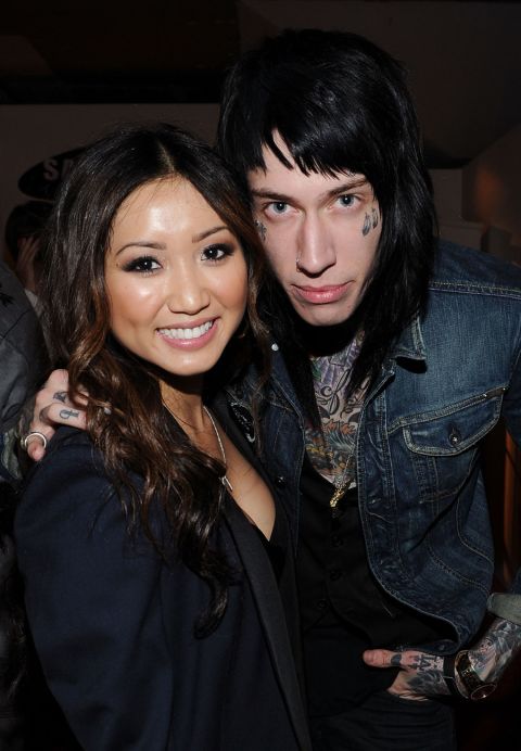 Heavily tattooed and pierced musician Trace Cyrus, singer Miley's brother, with actress Brenda Song.