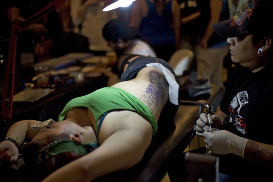 A tattoo artist works during the II Tattoo Expo in Guatemala City on June 16, 2012. 