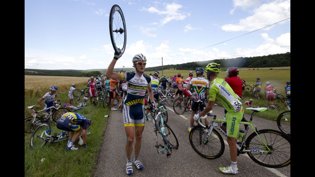 Sweden's Gustav Larsson, center, and Italy's Daniel Oss were among the 30 riders involved in the crash Friday.