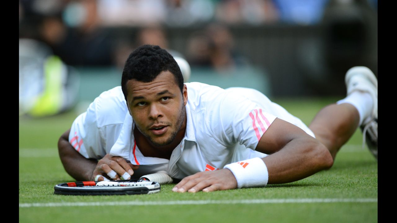 Tsonga looks up after spilling to the grass chasing a shot against Murray.