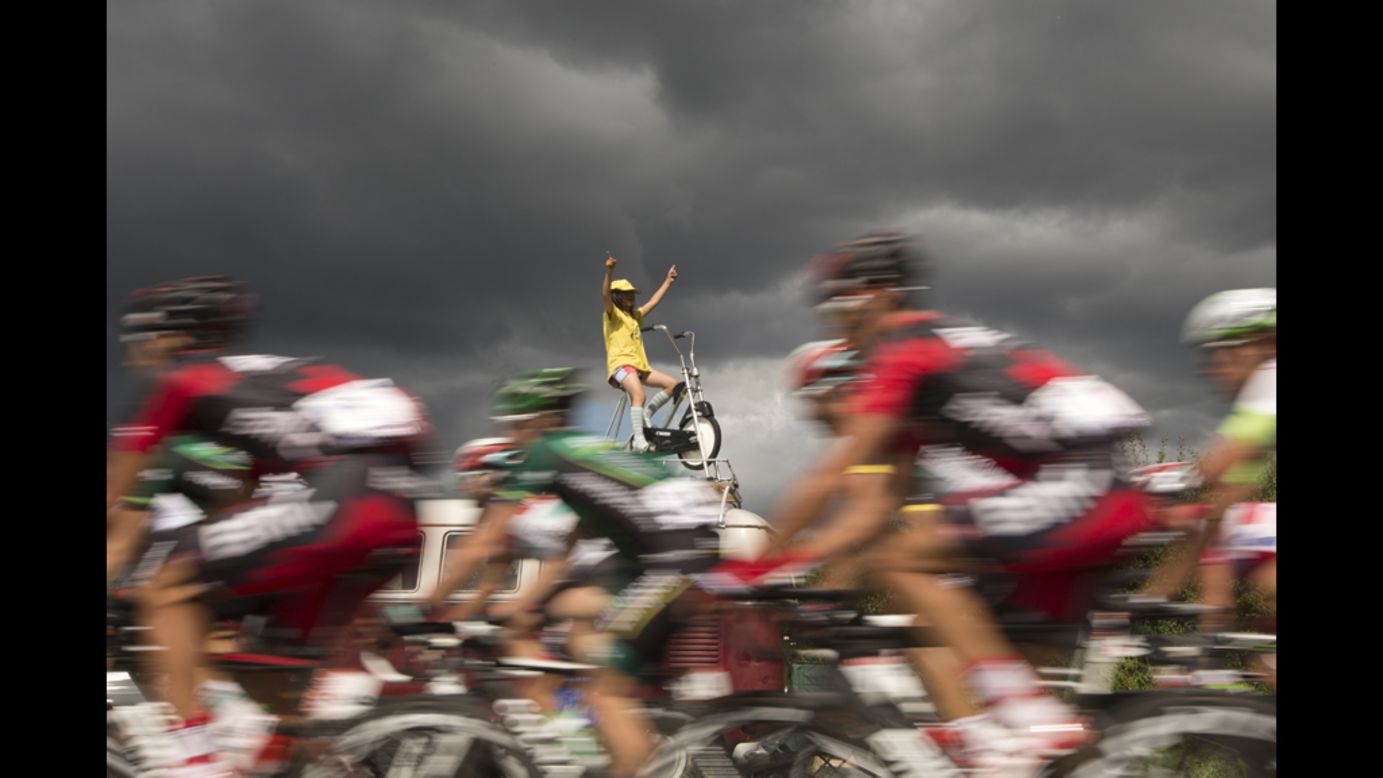 A fan wearing a yellow jersey cheers on the pack riding in Metz on Friday.