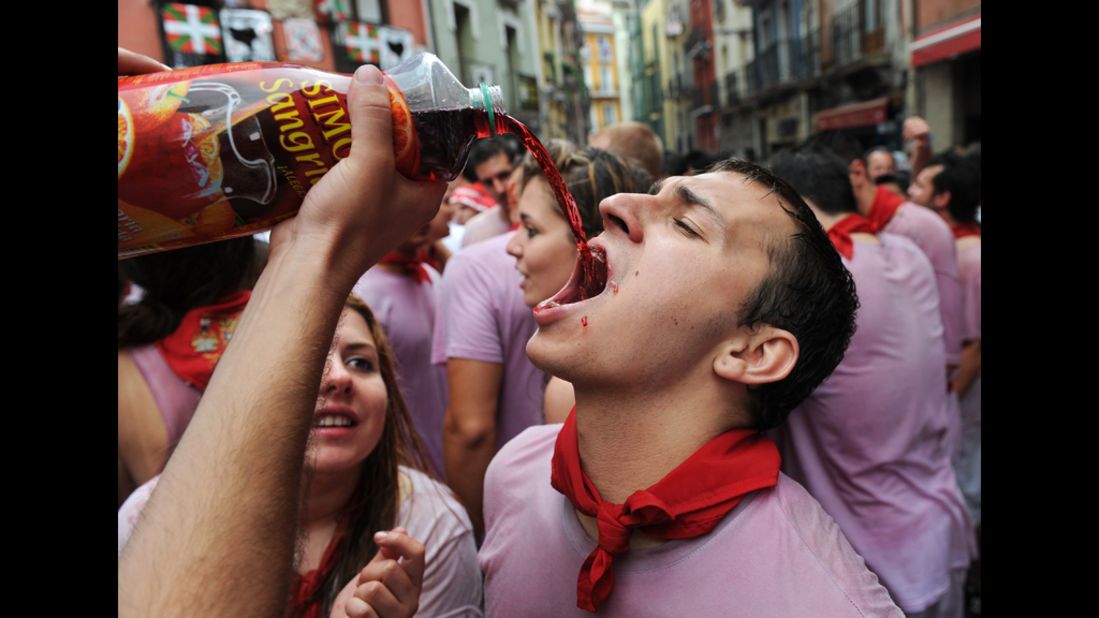 A participant gulps sangria Friday during the Chupinazo, which marks the first day of the annual event.
