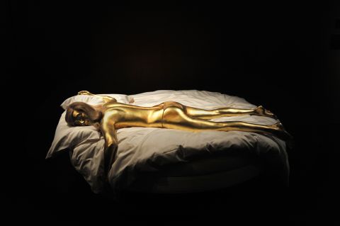 A replica of the character Jill Masterson, suffocated when she was painted with gold in "Goldfinger,"  is a centerpiece of the newly-opened James Bond exhibition in London.