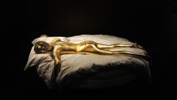 A replica of the character Jill Masterson, suffocated when she was painted with gold in "Goldfinger,"  is a centerpiece of the newly-opened James Bond exhibition in London.