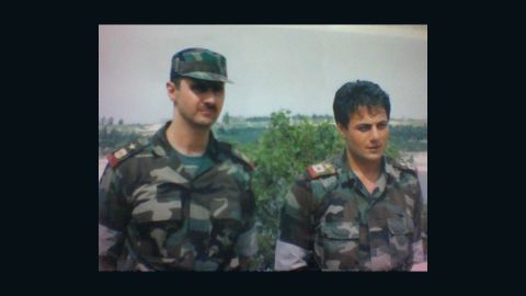 Brig. Gen. Manaf Tlas, right in an undated photo with Bashar al-Assad, has been a key member of the Syrian president's regime.