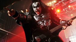 Gene Simmons points to camera while performing