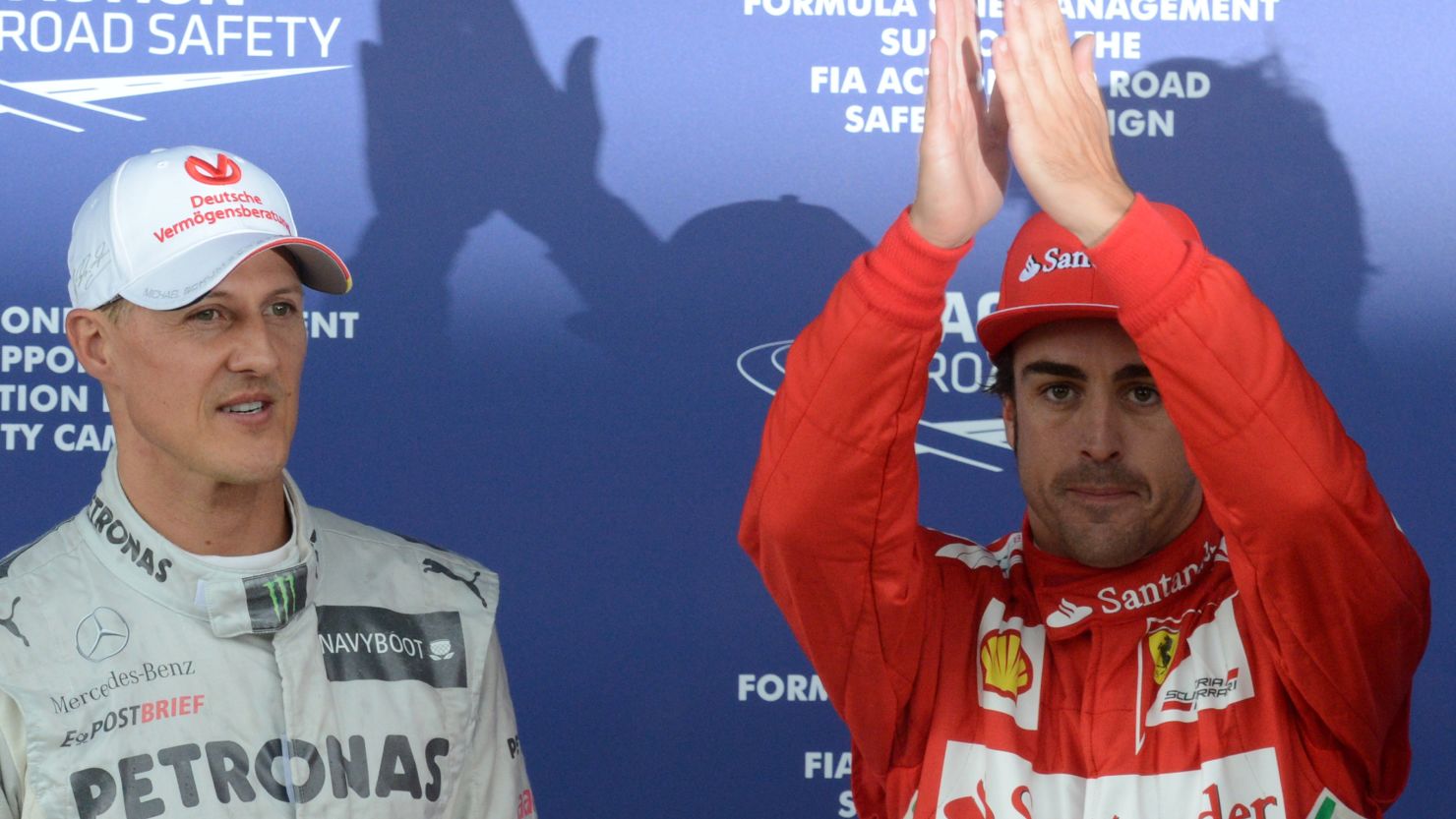 Fernando Alonso (right) celebrates his pole at Silverstone with third-fastest Michael Schumacher 