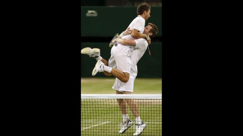 Britain's Jonathan Marray and Denmark's Frederik Nielsen celebrate championship point during the men's doubles final. Marray is the first Briton since 1936 to win a men's doubles title at Wimbledon since 1936. 