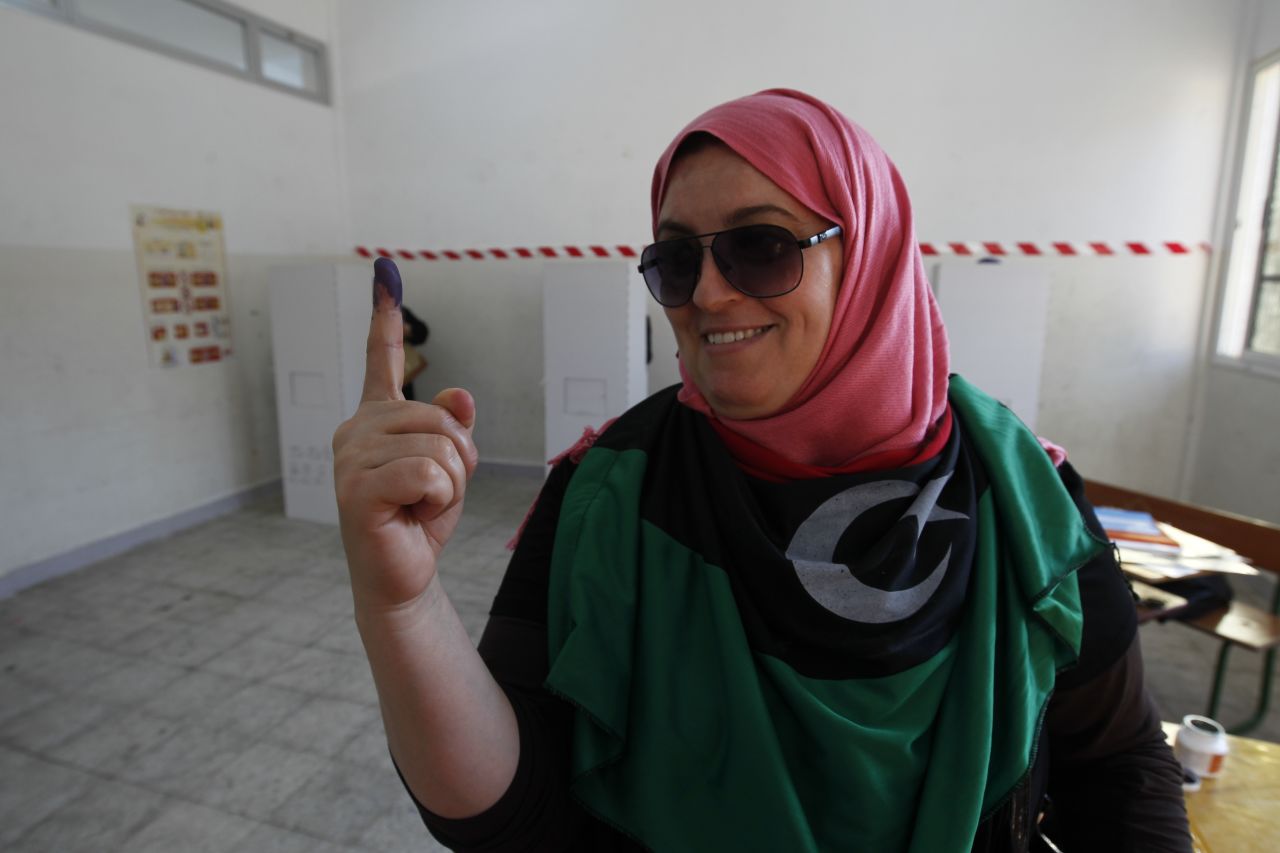 A Libyan woman shows her inked finger after casting her ballot at a polling station in Benghazi during Libya's General National Assembly election on Saturday.
