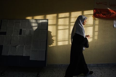 After casting her ballot, a Libyan woman leaves a polling station in Tripoli.