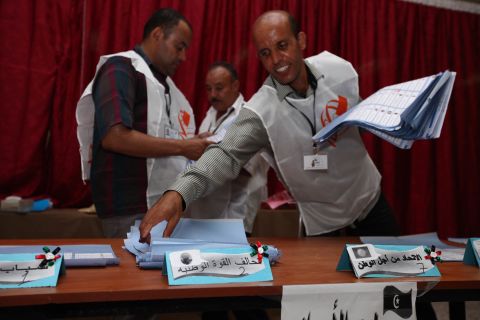 Election officials begin sorting ballots at a polling station in Tajura following Libya's General National Assembly election.