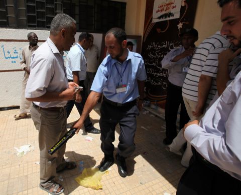 A voter goes through a security checkpoint outside a polling station in the Abu Slim neighbourhood of Tripoli.