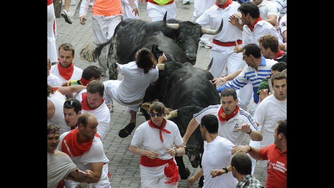 People try to escape the horns and hooves of the bulls on Saturday.