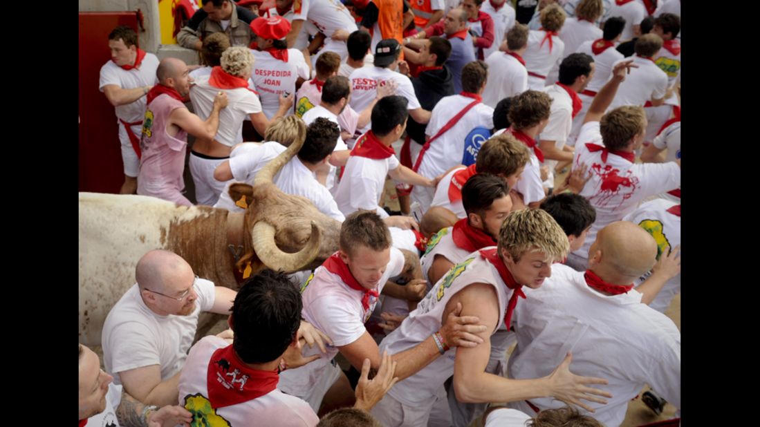 Runners push past each other to escape the bulls.
