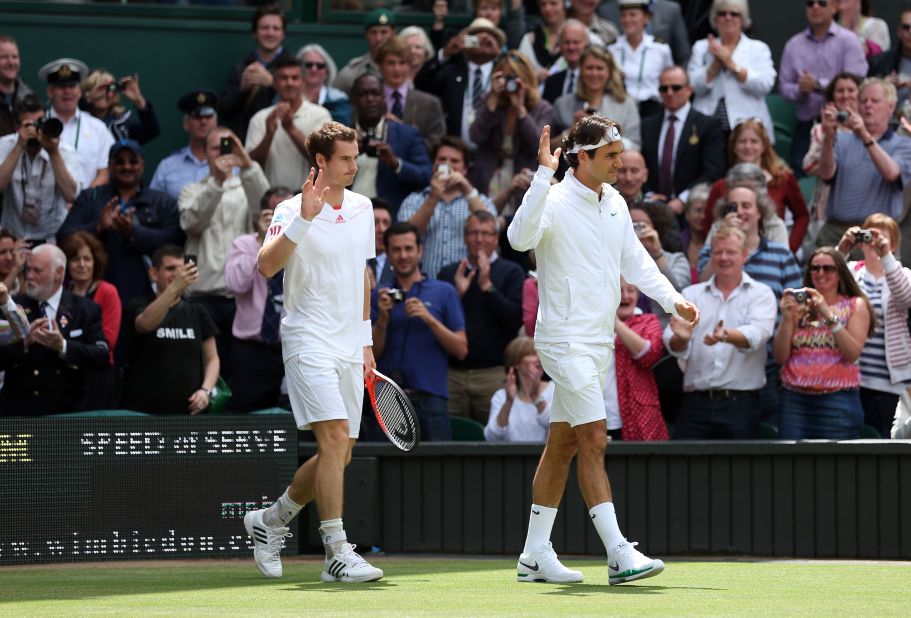 Murray and Federer enter the court prior to the men's singles final match on the final day of Wimbledon on Sunday.