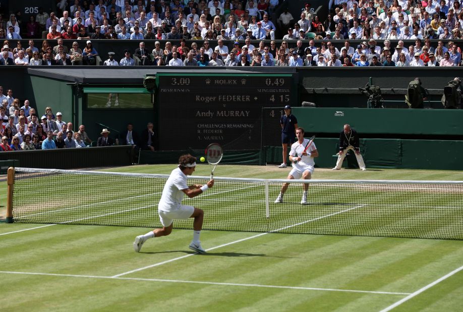 Federer, left, returns a shot from Murray during the men's singles Wimbledon championship in London on Sunday.