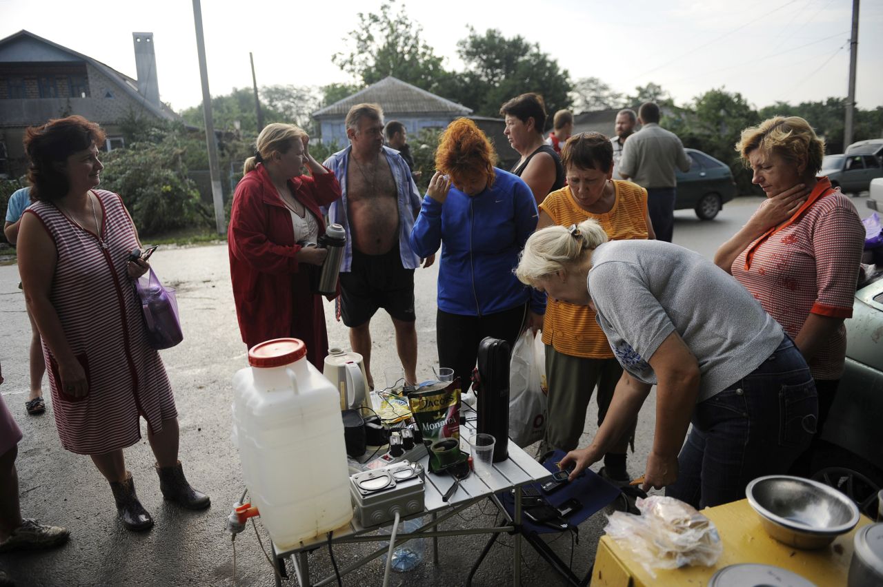 People gather to charge cell phones in Krymsk after flooding knocked out power to tens of thousands of residents.