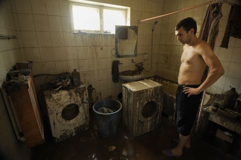 A resident of Krymsk walks through his damaged home after floodwaters receded Sunday.