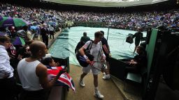 Britain's Andy Murray leaves court during a rain delay in his men's singles final match against Switzerland's Roger Federer on day 13 of the 2012 Wimbledon Championships tennis tournament at the All England Tennis Club in Wimbledon, southwest London, on July 8, 2012. AFP PHOTO / GLYN KIRK     RESTRICTED TO EDITORIAL USE        (Photo credit should read GLYN KIRK/AFP/GettyImages)