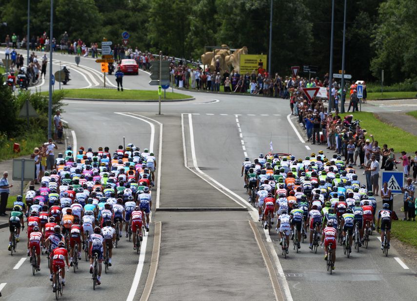 The main group, known as the peloton, departs from Belfort at the start of the race Sunday.