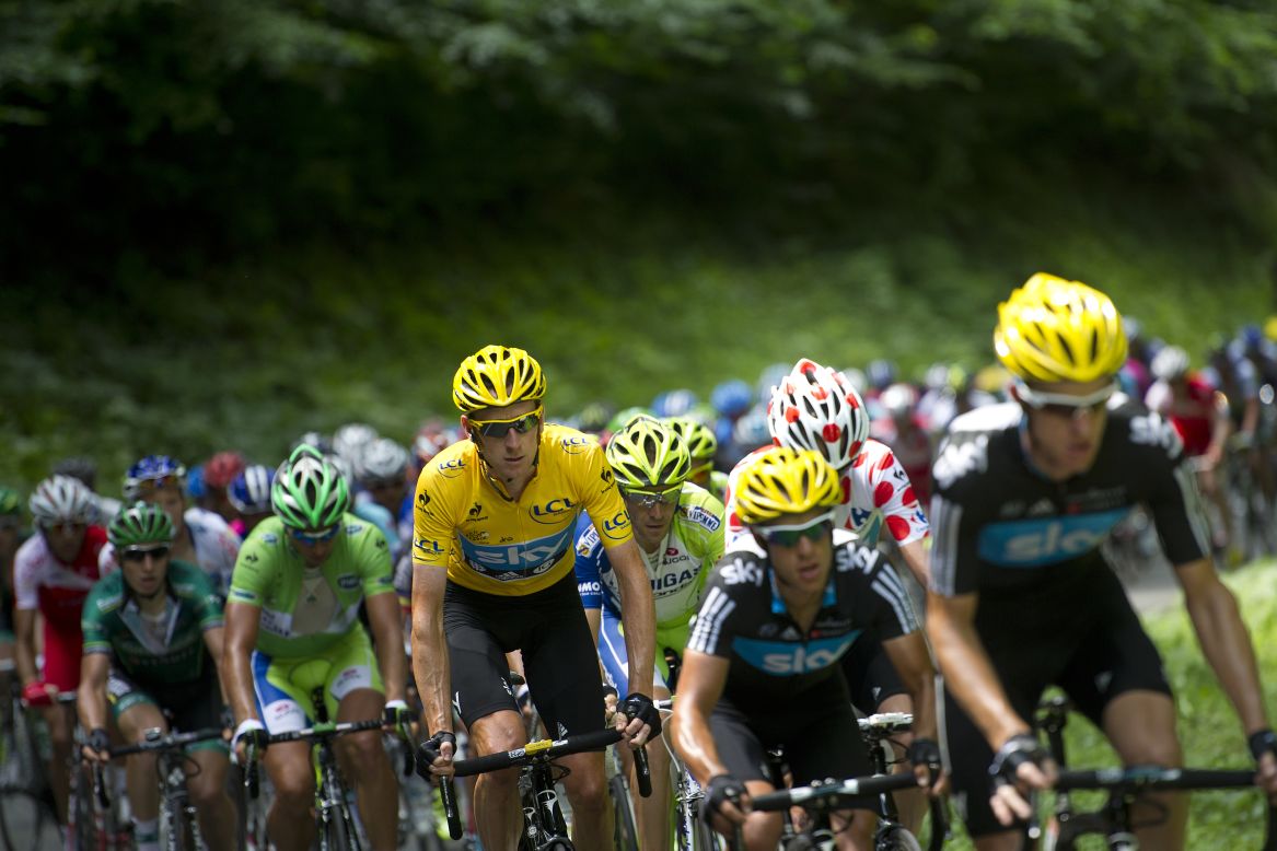 Overall leader Bradley Wiggins of Great Britain rides in the peloton with his Team Sky teammates Sunday.