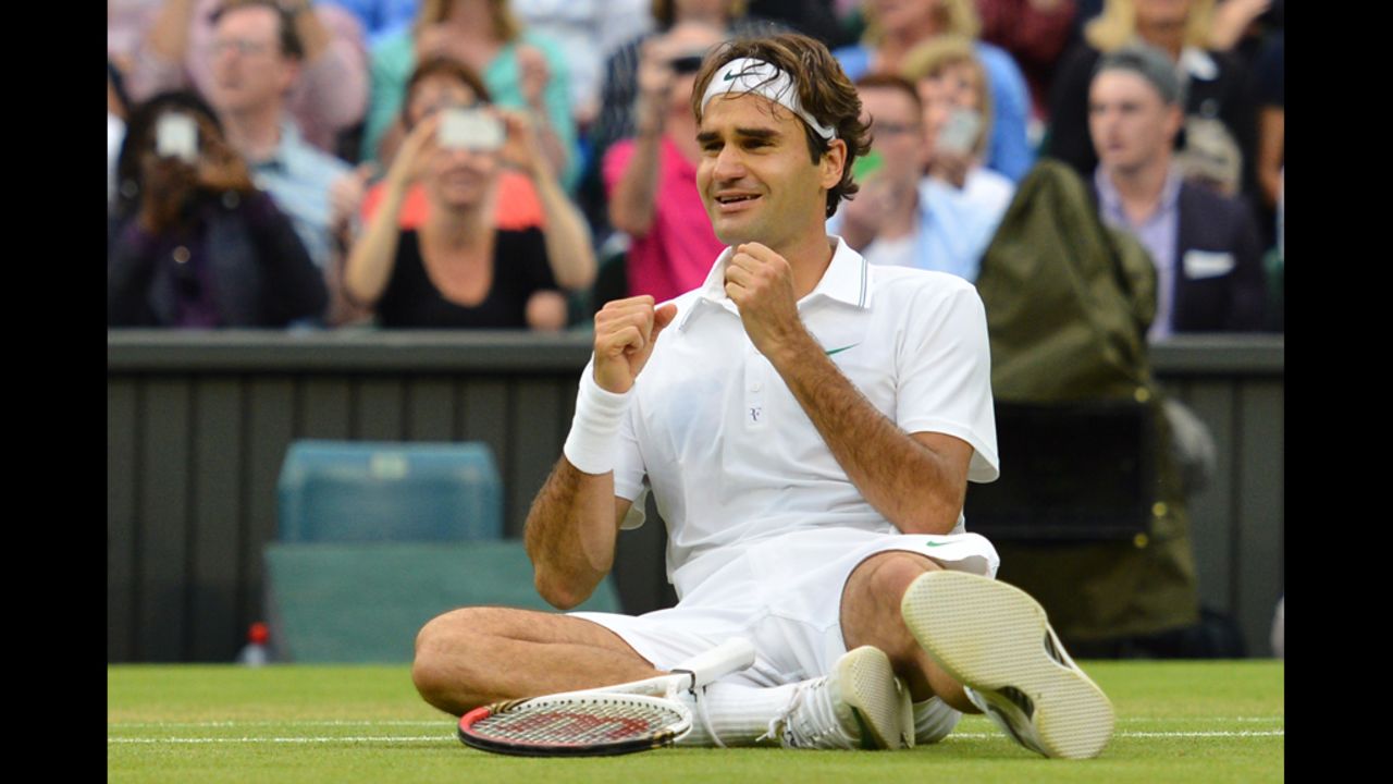 Switzerland's Roger Federer falls to the floor in celebration after his men's singles final victory over Britain's Andy Murray on day 13 of the 2012 Wimbledon Championships tennis tournament at the All England Tennis Club in Wimbledon, southwest London, on July 8, 2012. Federer won the match 4-6, 7-5, 6-3, 6-4. AFP PHOTO / LEON NEAL     RESTRICTED TO EDITORIAL USE        (Photo credit should read LEON NEAL/AFP/GettyImages)