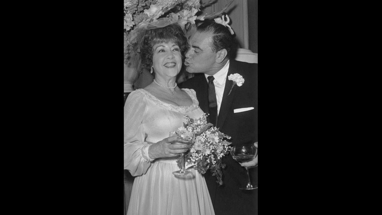 Borgnine leans in to kiss actress Ethel Merman during their 1964 wedding reception in Beverly Hills, California. They broke up in about a month and were officially divorced the next year.