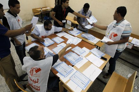 Election workers count votes at a polling station during the election Saturday in Benghazi.