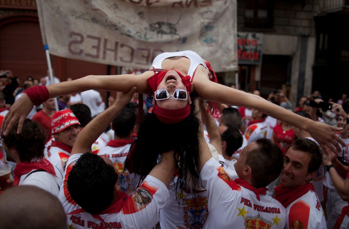 Revelers celebrate during the Pena Voladora parade on Estafeta Street on Saturday, July 7.