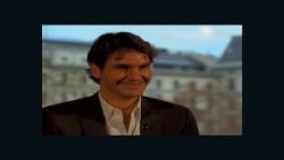 Roger Federer can't stop laughing during an interview with Pedro Pinto